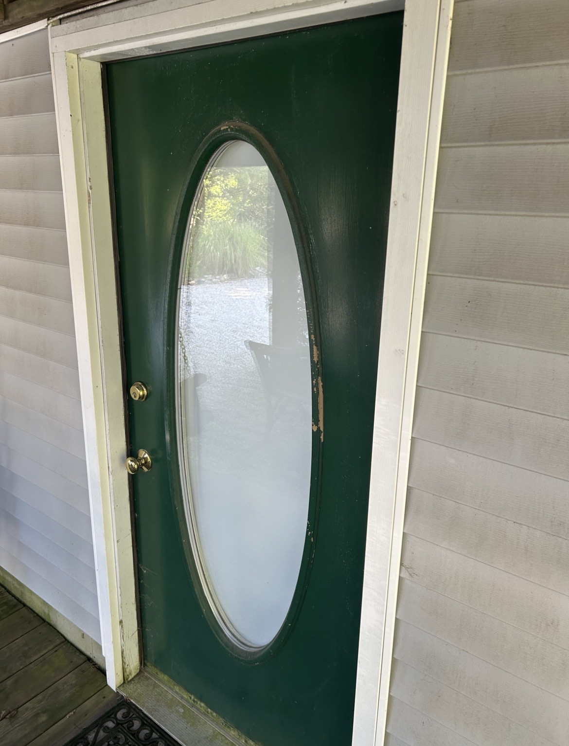 Professional exterior window cleaning on a coastal residential home showing crystal clear glass