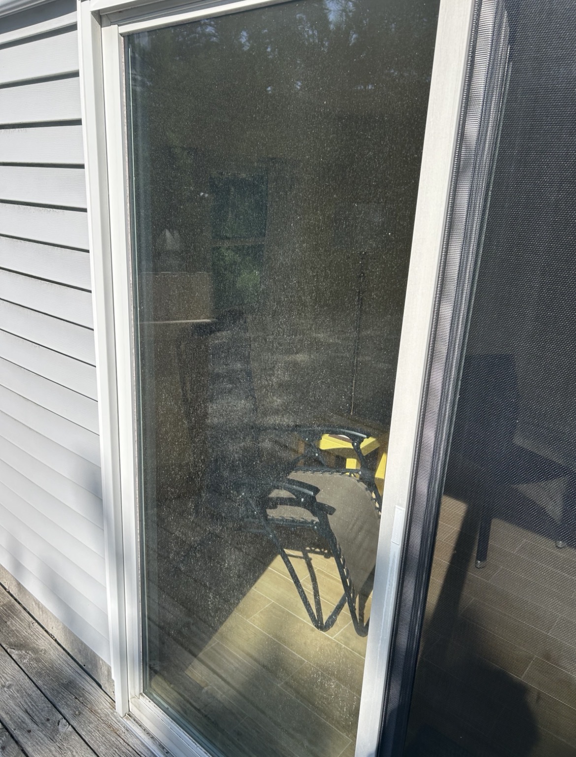 Professional exterior window cleaning on a coastal residential home showing crystal clear glass before service