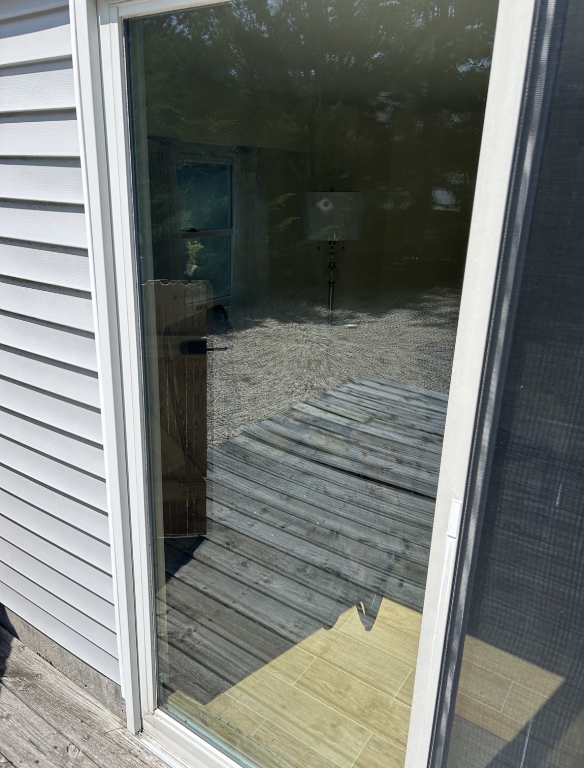 Pristine shore house with streak-free windows reflecting clear sky after professional cleaning